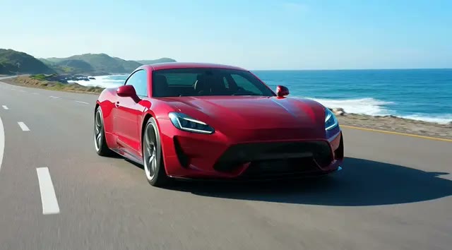 Grok: a red sports car on a coastal highway, clean motion at a value price.